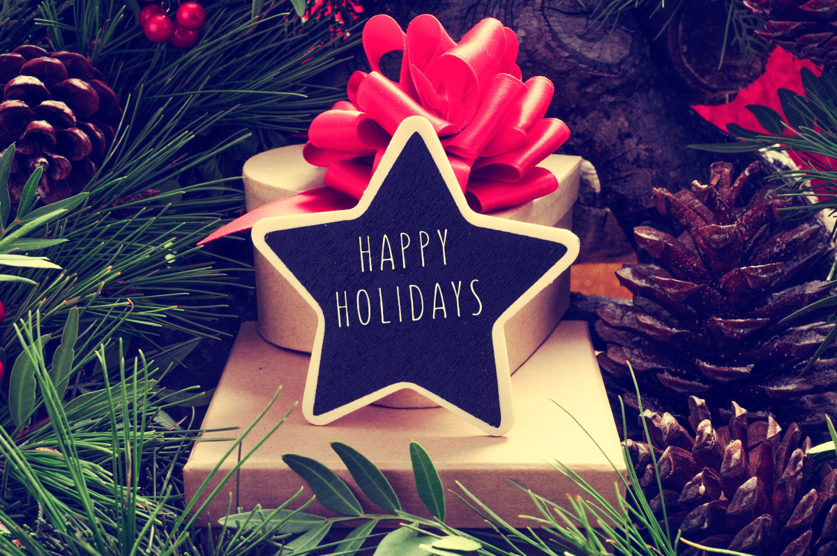 Star with 'Happy Holidays' Text atop Boxes of Presents Nestled in a Christmas Tree